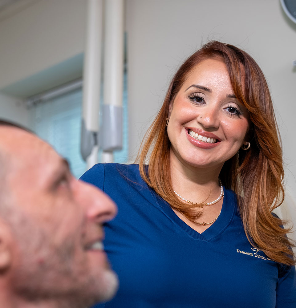 staff member helping patient within the dental center for their dental procedure