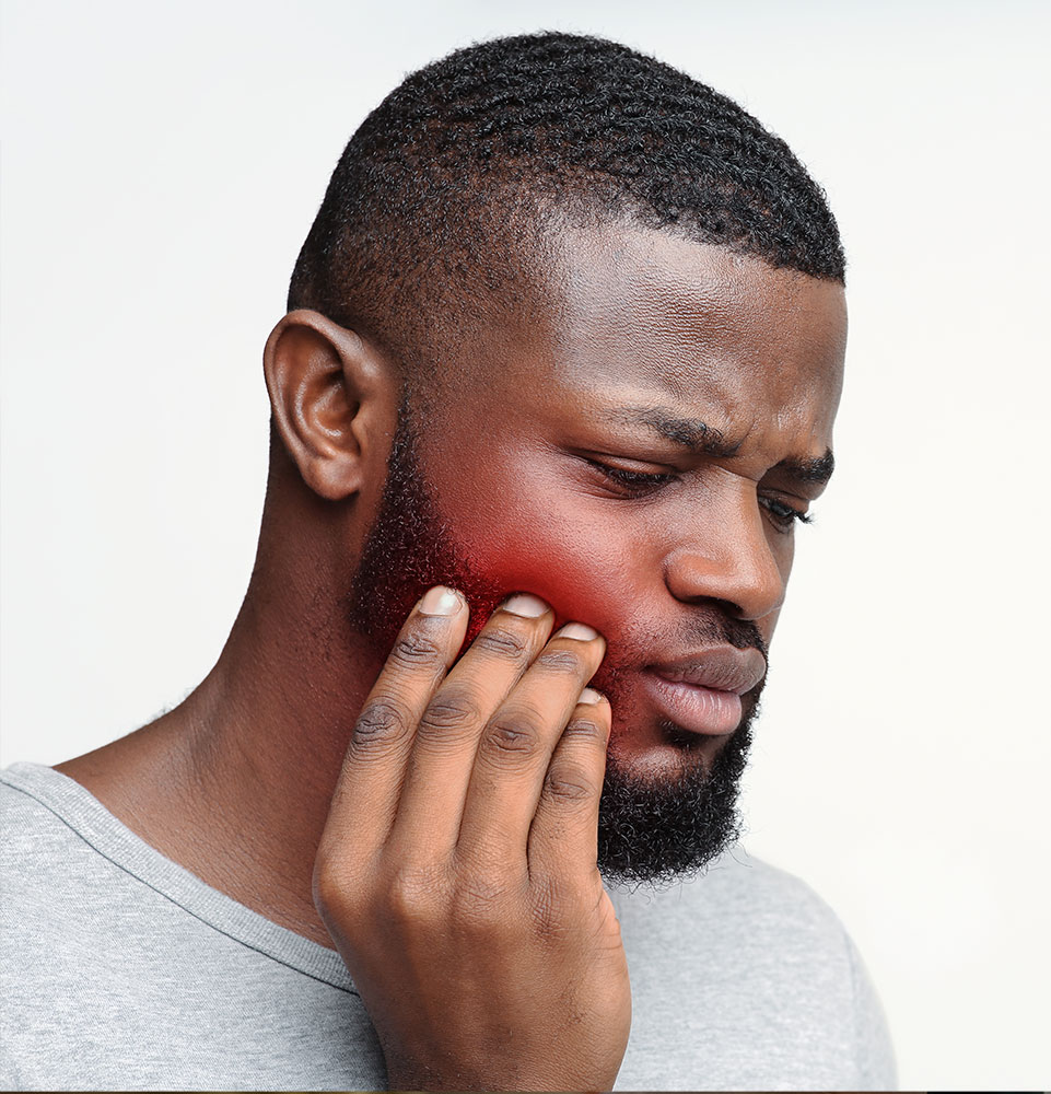 Young sad man having pain in his teeth