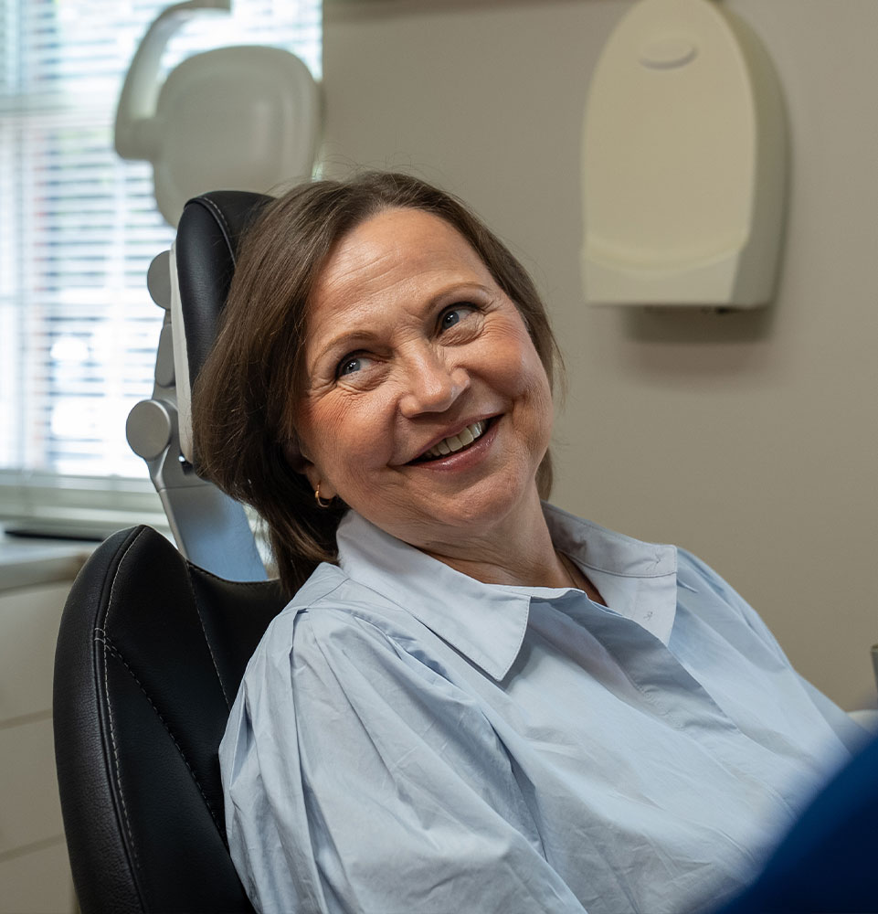patient smiling brightly while going over dental procedure