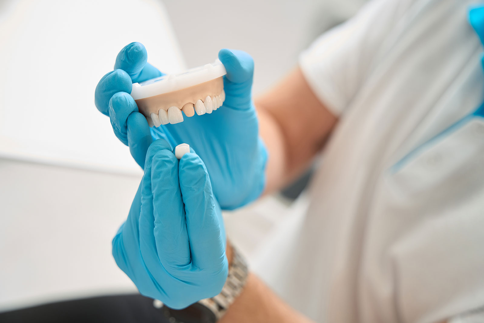 close up of staff member showing dental crown