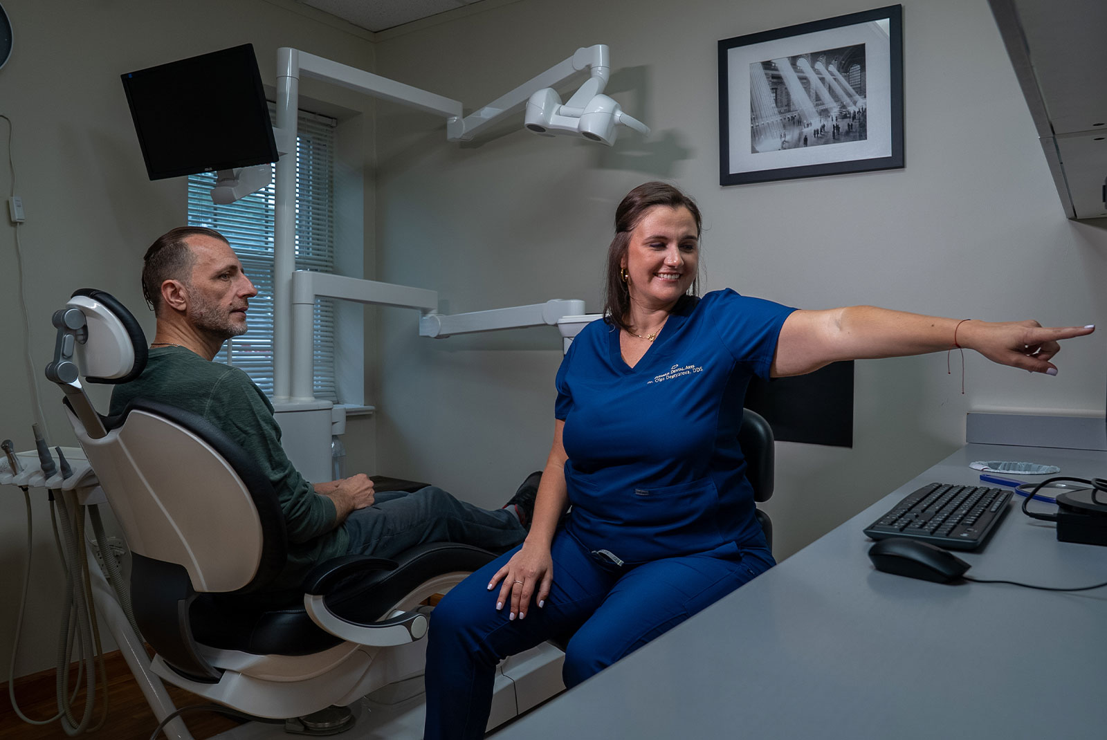 doctor goin over dental patient procedure information within the dental center