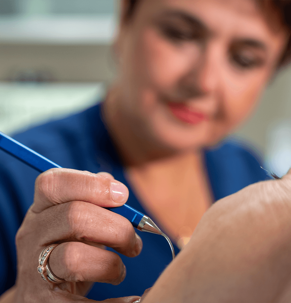 doctor using laser dental procedure on patient
