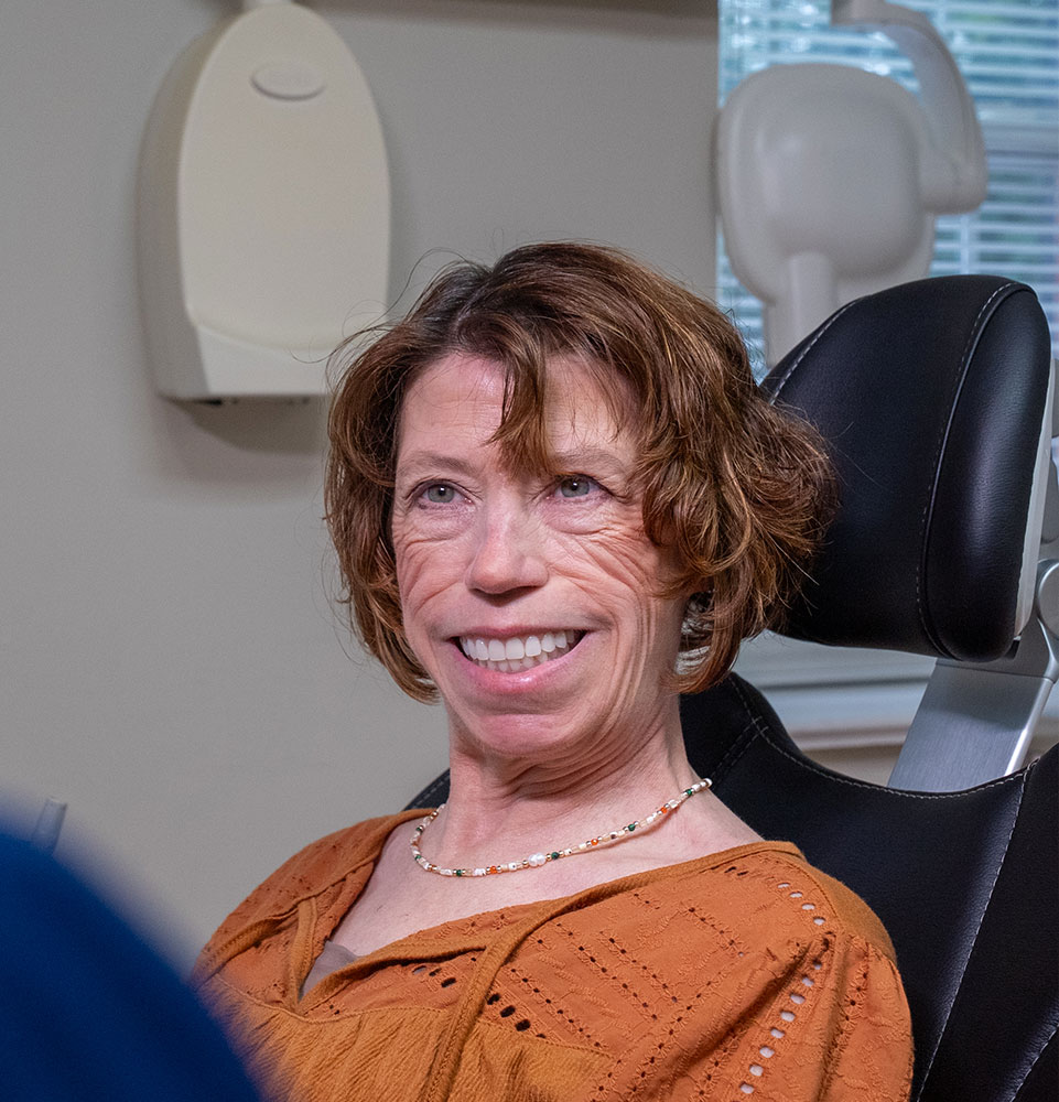 patient smiling brightly while going over dental procedure