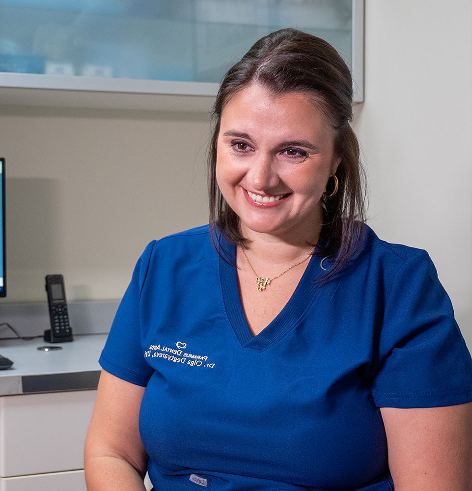 doctor smiling brightly while going over dental veneer procedure information